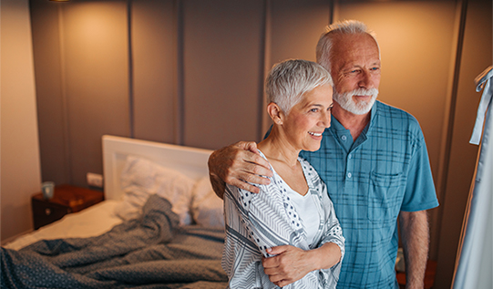Older couple sitting at desk working Older couple sitting at desk working