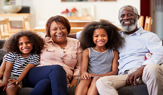 Grand parents with grand kids sitting on couch