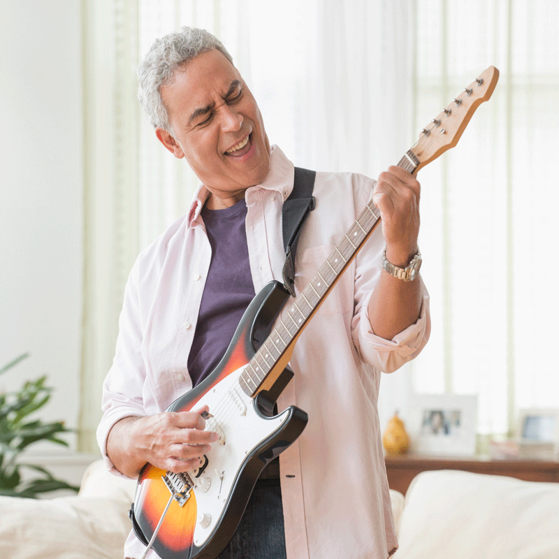 Older male playing guitar